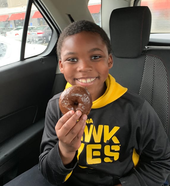 boy holding donut