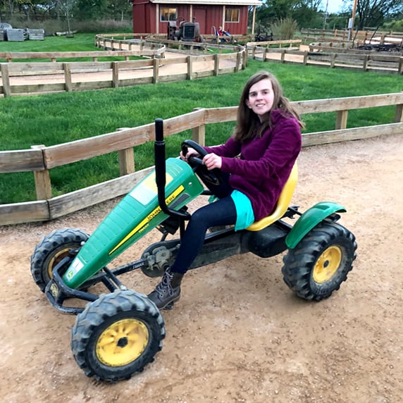 girl on pedal car